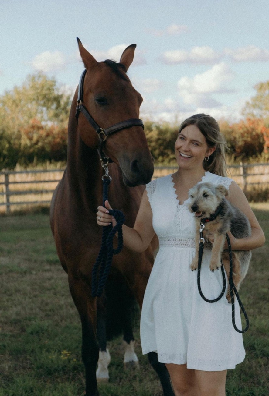 Ellie Spencer outdoors with her horse and dog