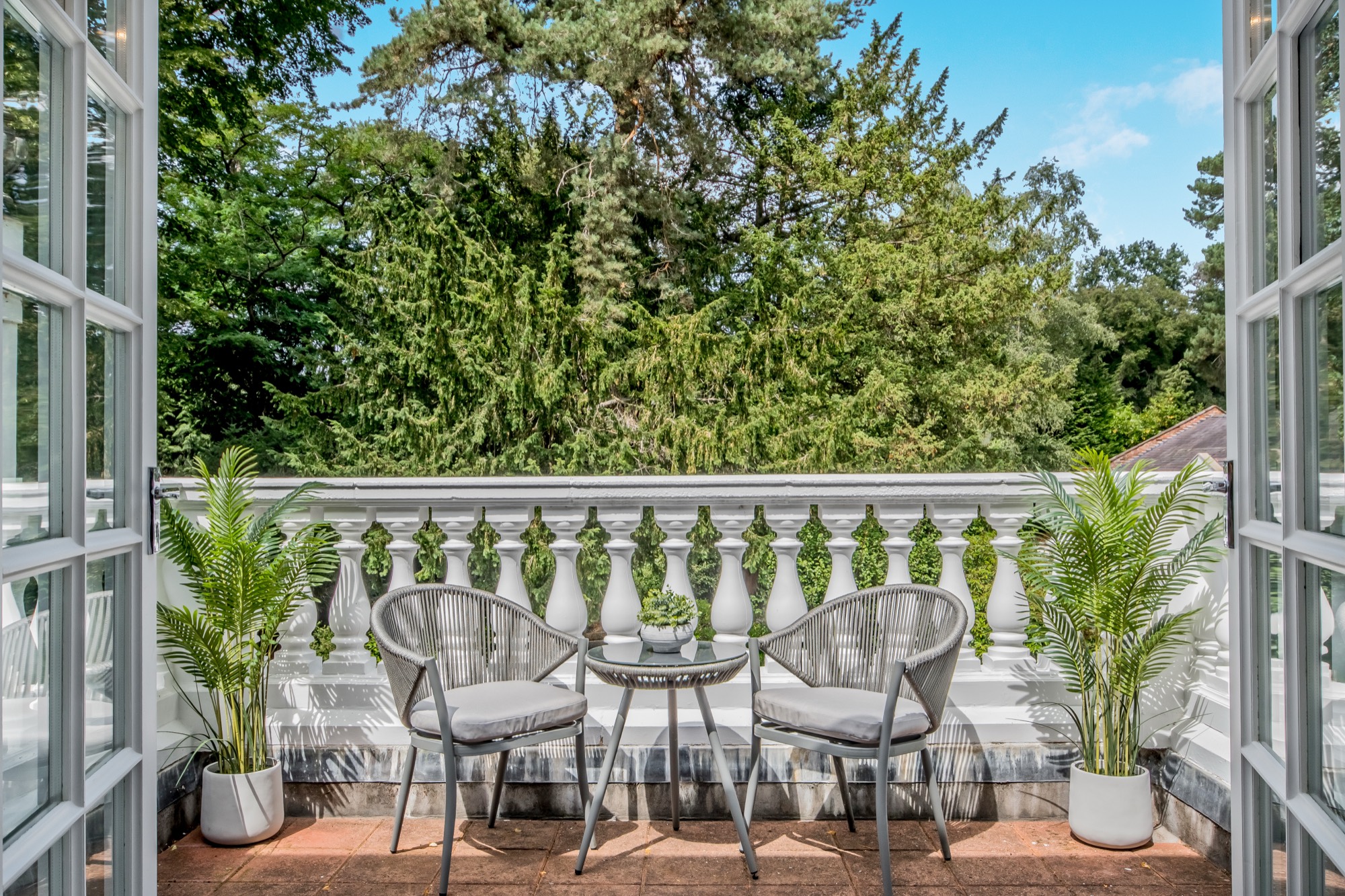 Balcony seating seen through open French doors