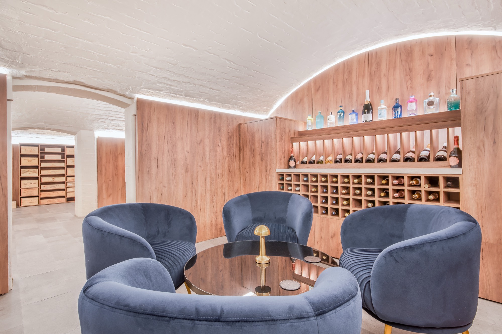 Vaulted cellar fitted out as a wine room and seating area