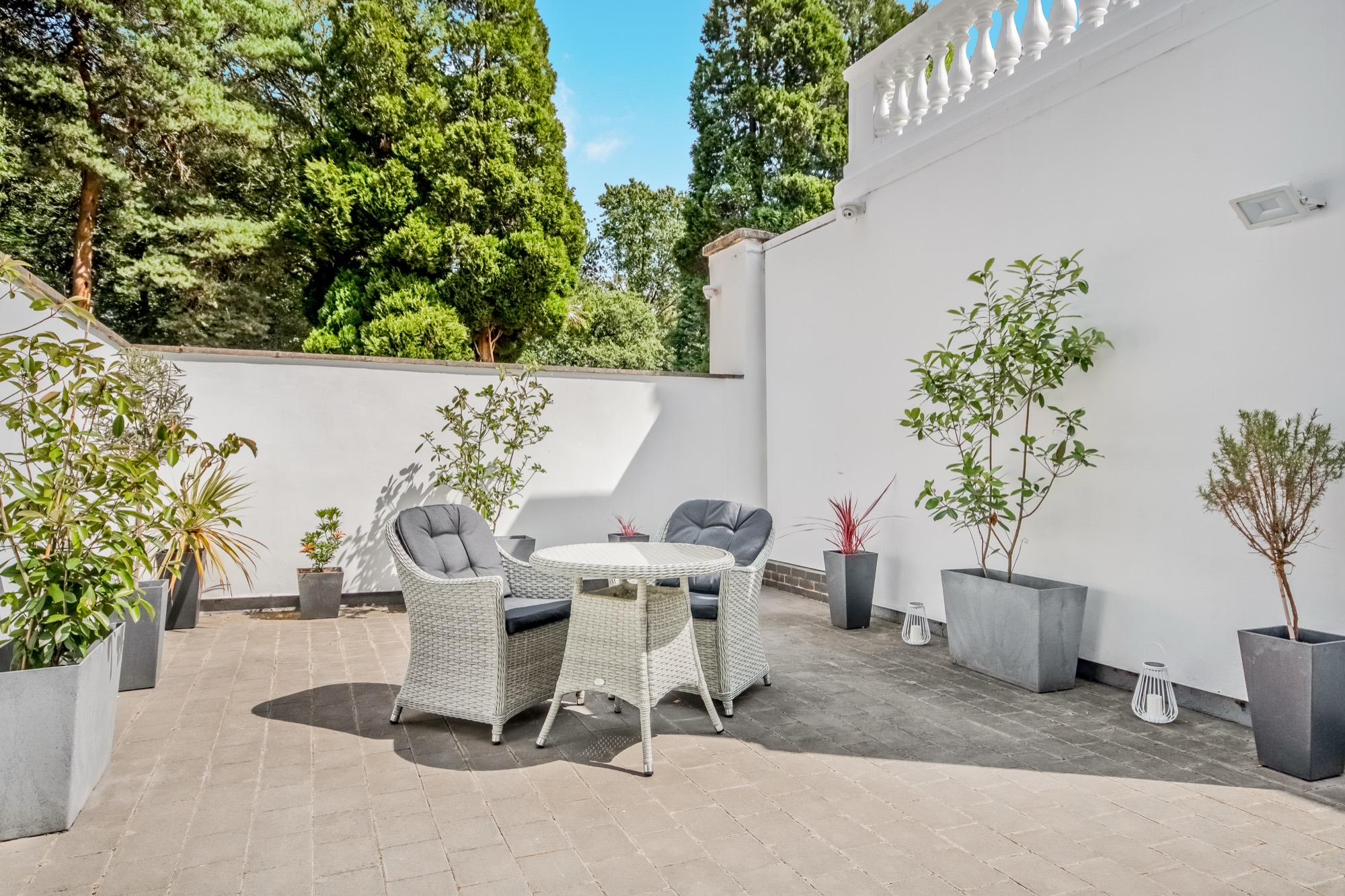 Walled courtyard garden with table and chairs