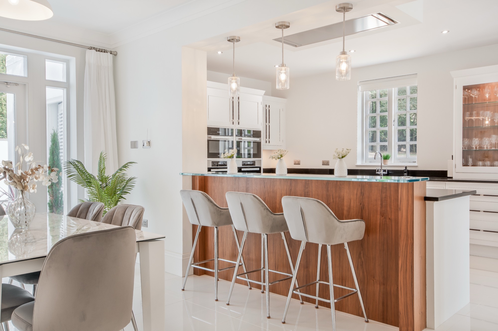 Open-plan kitchen with walnut island and pendant lighting
